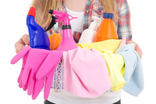 Cleaning professional wearing PPE while preparing safe cleaning equipment
