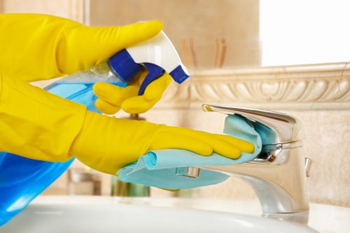 Team member trained in safe cleaning procedures with protective gear